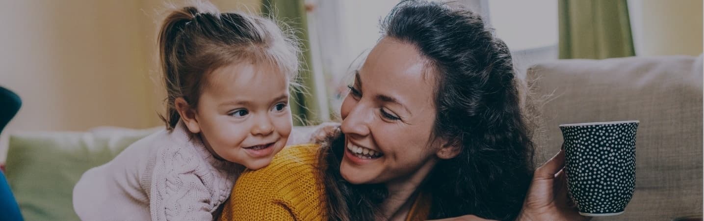 mother and daughter having fun online