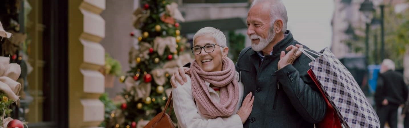 Smiling mature couple shopping during the holidays