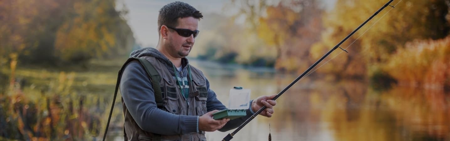 Man choosing bait for fishing