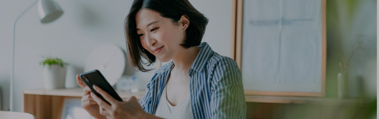 Pretty young Asian woman using cell phone